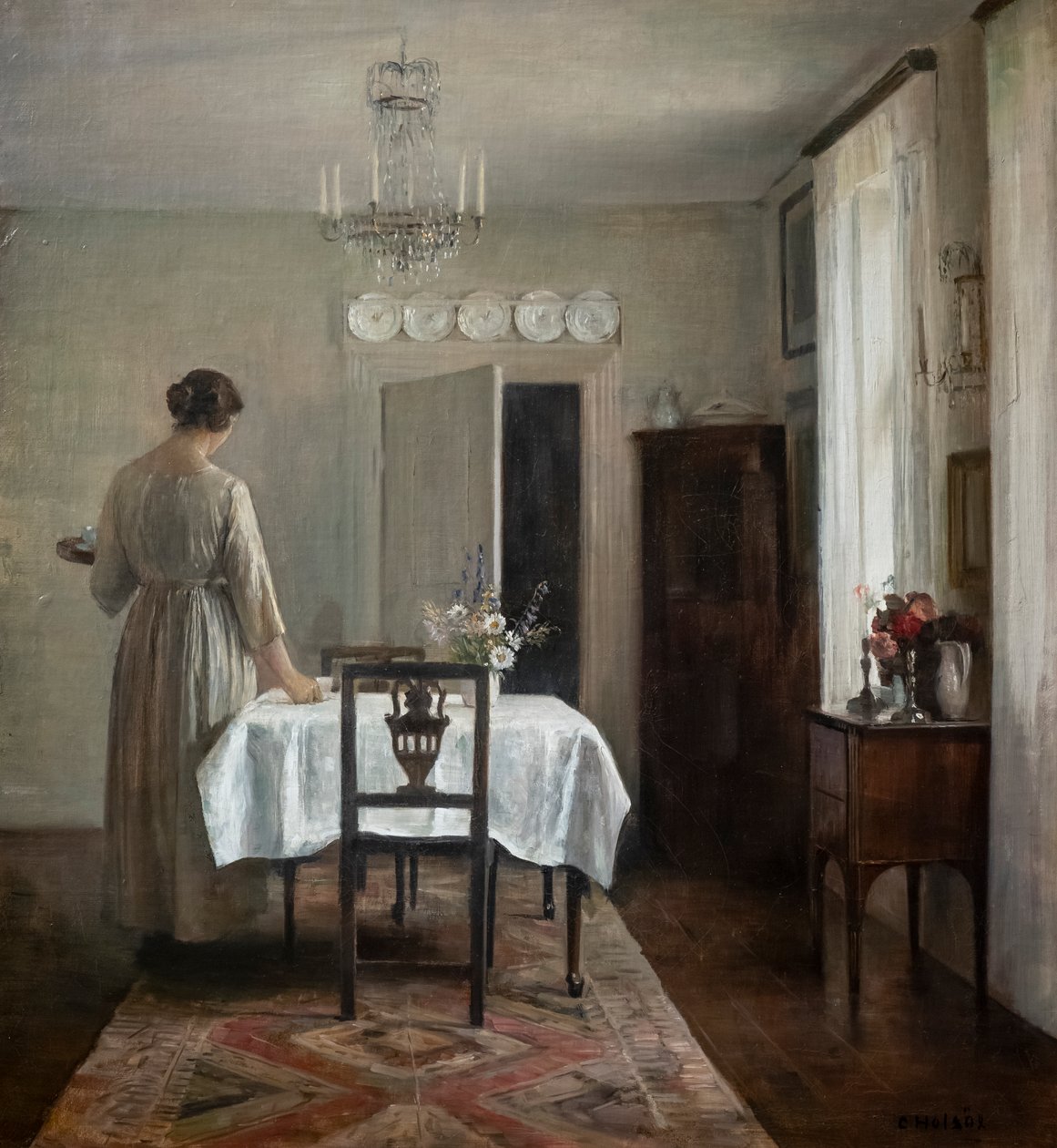 A mulher do artista a pôr a mesa de Carl Holsoe