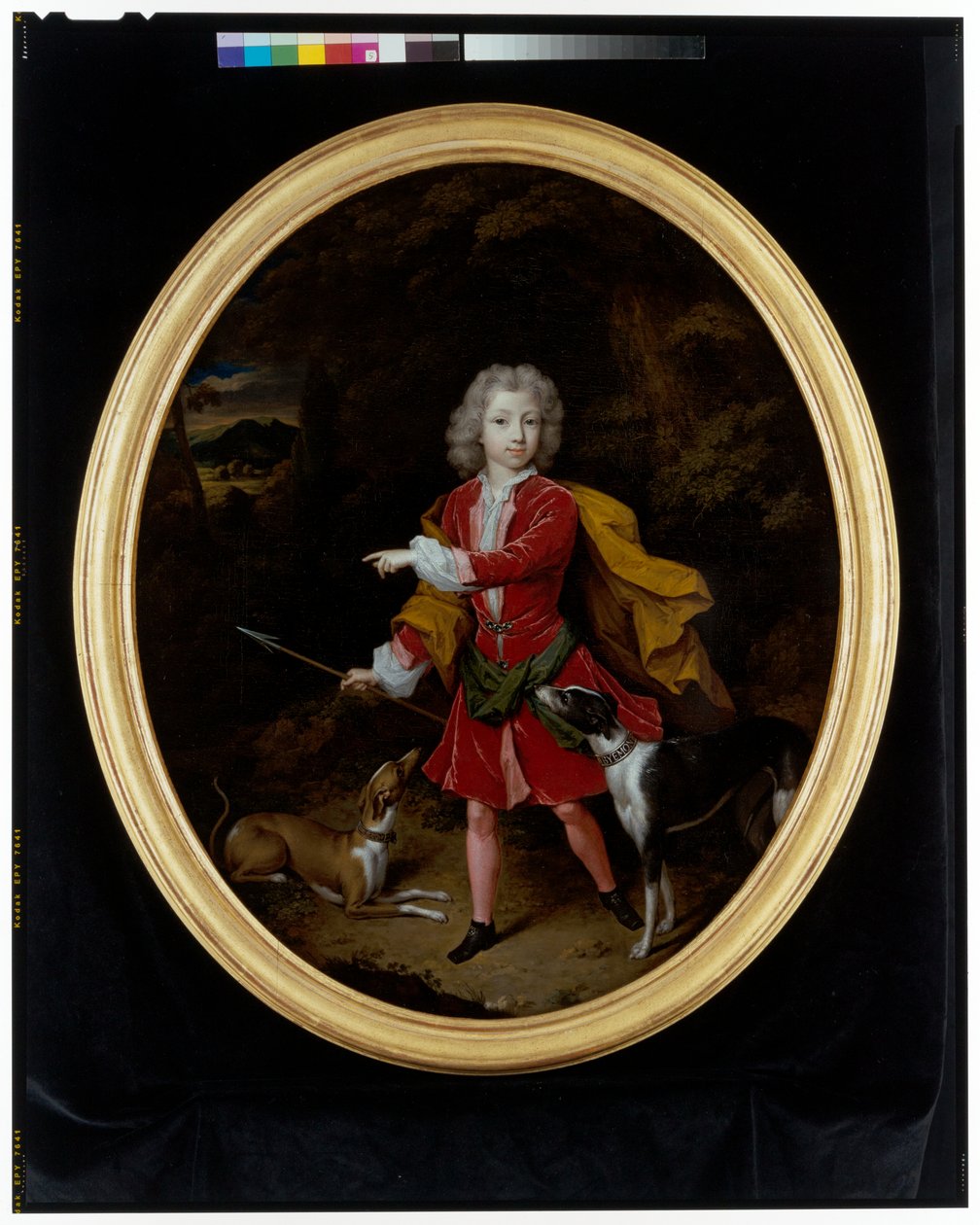 Retrato de um jovem acompanhado por um par de cães de caça numa paisagem arborizada de Constantin Netscher