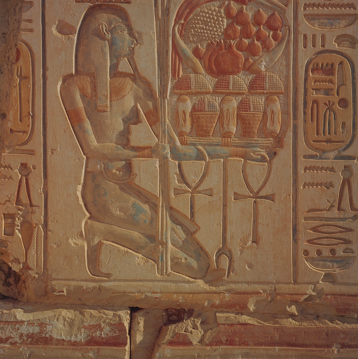 Ajoelhando figura apresentando cestas de comida, do Templo de Ramsés II, Novo Reino, c.1304-1270 aC (relevo de arenito pintado) de Egyptian 19th Dynasty