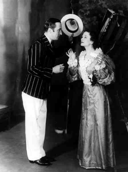 George Curzon como Algernon Moncrieffe (Algy) e Ursula Jeans como Cecily Cardew, em The Importance of Being Earnest, de Oscar Wilde (1854-1900) no Old Vic Theatre, 5 de Fevereiro de 1934 (foto a p/b) de English Photographer
