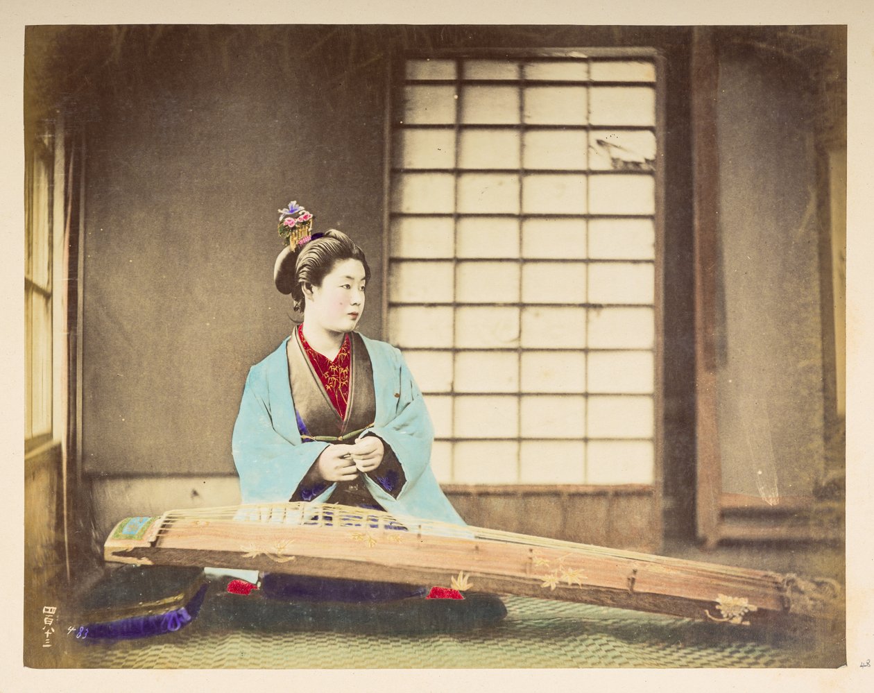 Raparigas cantoras [Japão], Retrato de estúdio de uma mulher japonesa, sentada com um instrumento de cordas (uma espécie de cítara) descansando no chão à sua frente, Fotógrafa: Desconhecida Colecção Lucas: Registo fotográfico da digressão mundial de Charle de English Photographer