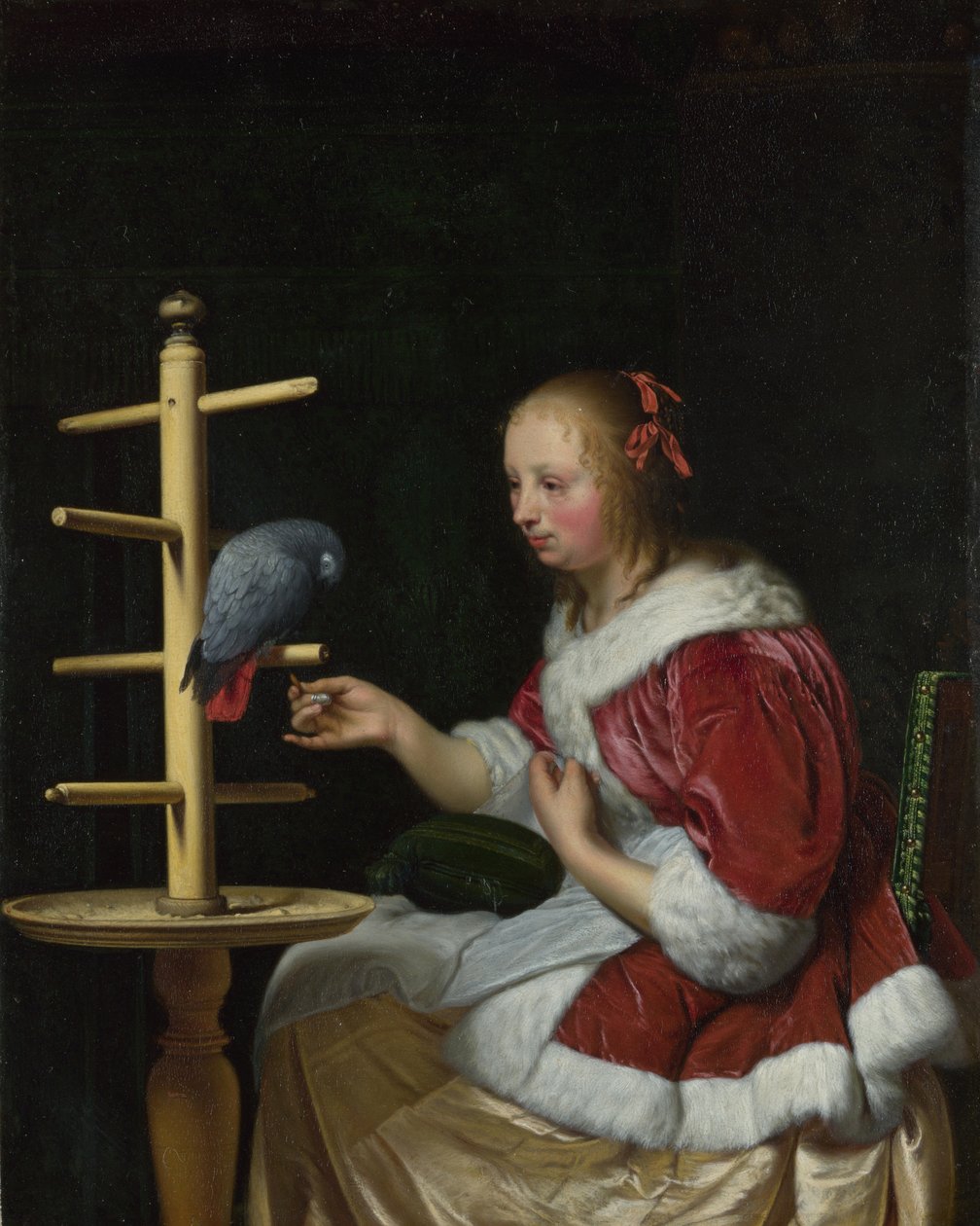 Uma Mulher de Casaco Vermelho alimentando um Papagaio, ca. 1663 de Frans van Mieris the Elder