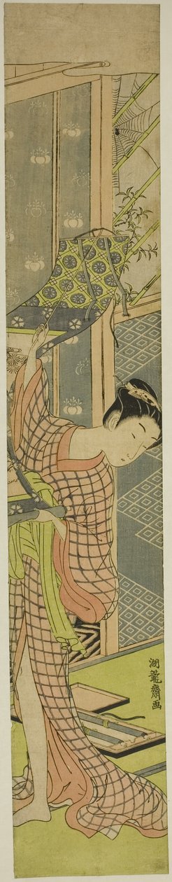 Jovem mulher pendurando uma pintura de Isoda Koryusai