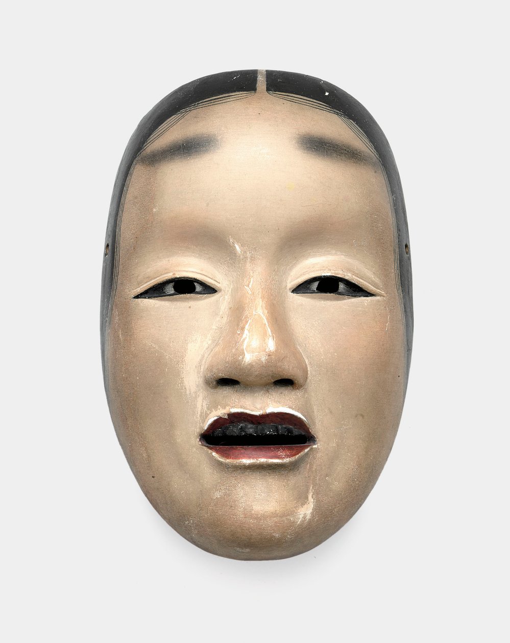 Uma máscara de madeira com fundo de gofun, pintada com sumi para os cabelos, olhos e dentes e vermelha para os lábios de Japanese School