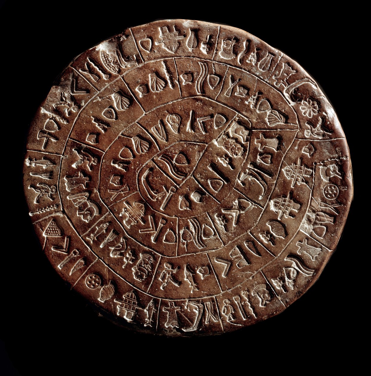 O disco de Phaistos (Phaistos Disk, Phaestos Disc) (Minoan Art - 1700 - 1600 BC) coberto com hieróglifos. de Minoan
