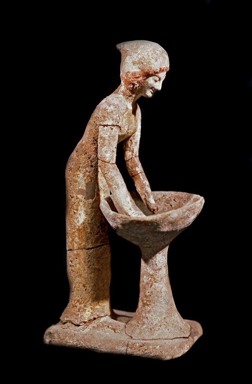 Arte micénica: figura de uma mulher a fazer o pico da farinha. Século XVI a.C. Estrasburgo, museu arqueológico de Mycenaean