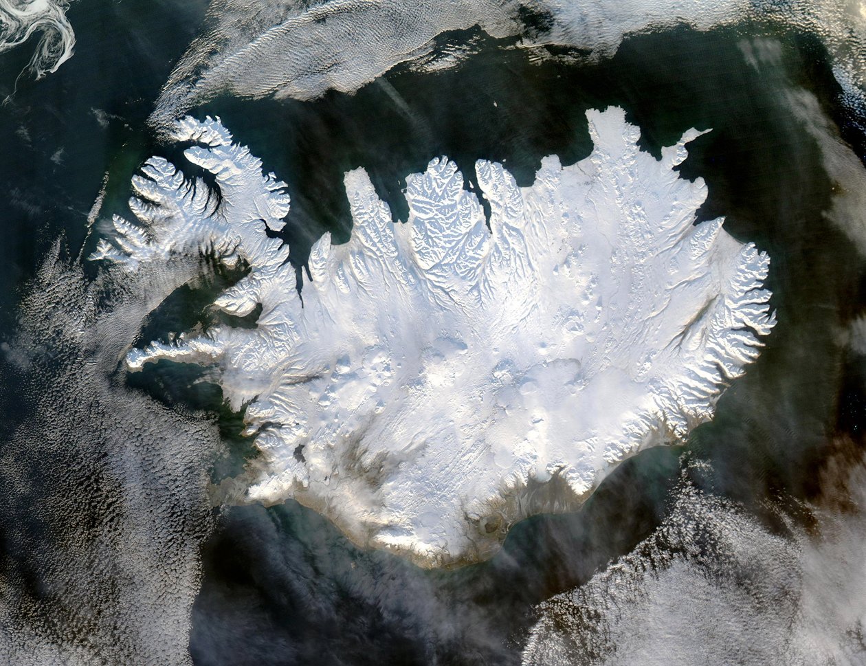 Imagem de satélite da Islândia em 28 de janeiro de 2004, mostrando-a coberta por um manto de neve e gelo que obscurece as geleiras permanentes e as calotas que existem o ano todo. Crédito NASA Inverno da ciência de National Aeronautics and Space Administration National Aeronautics and Space Administration