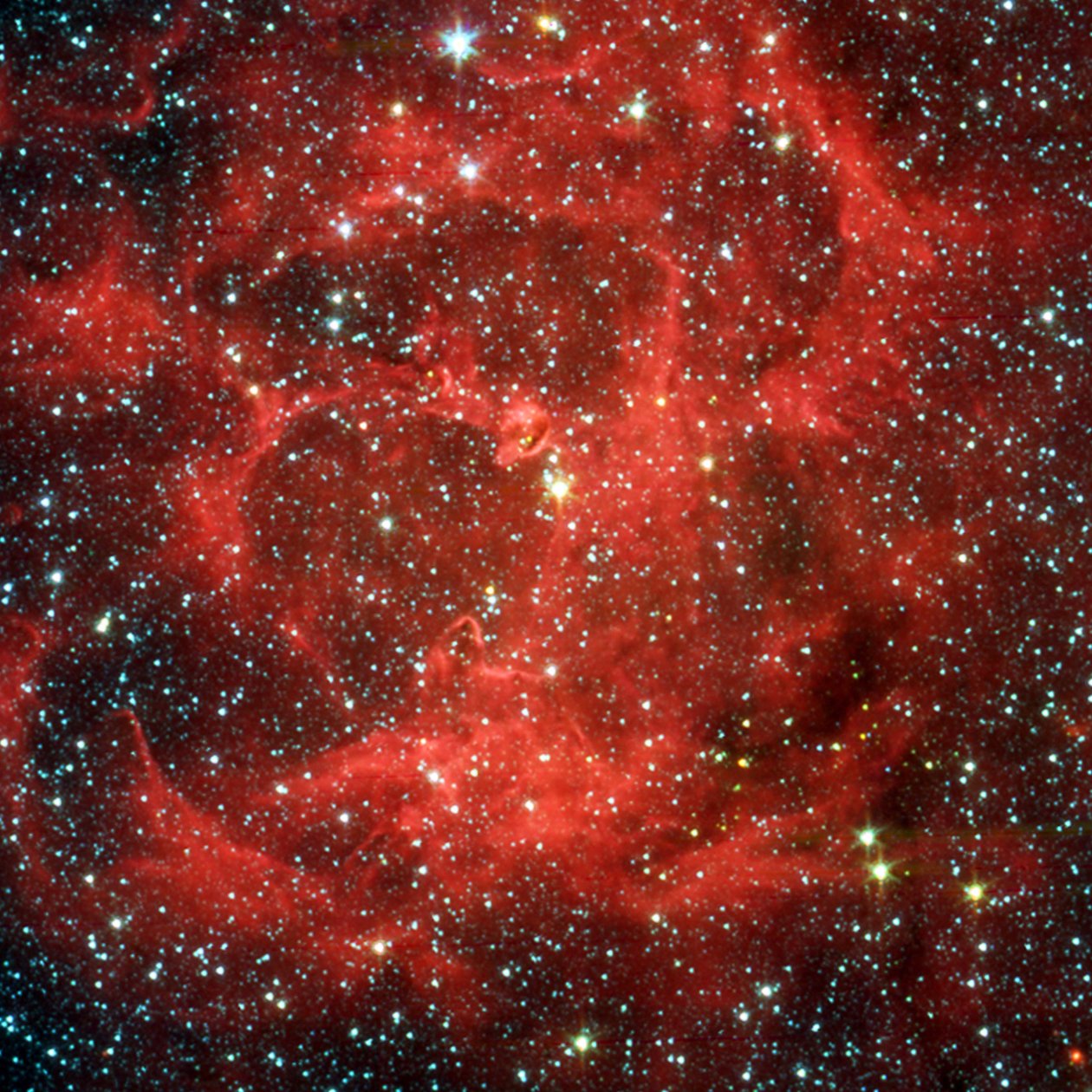 As visões de comparação do Telescópio Espacial Spitzer na luz visível e no infravermelho da brilhante Nebulosa Trífida, uma gigantesca nuvem de gás e poeira formadora de estrelas localizada a 5.400 anos-luz de distância no Sagitário. Credi de National Aeronautics and Space Administration National Aeronautics and Space Administration