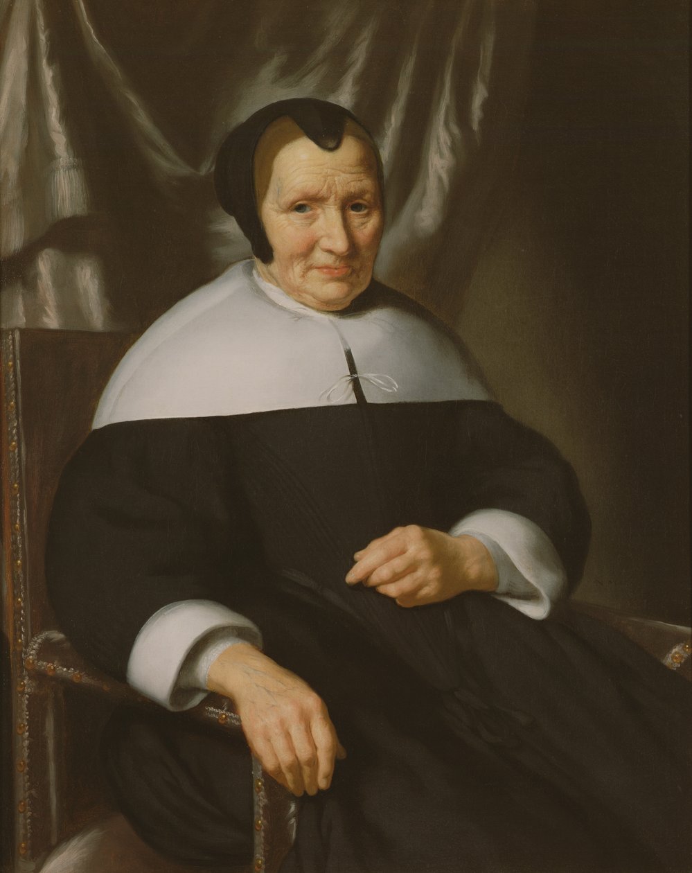 Retrato de uma senhora sentada em uma poltrona de Nicolaes Maes