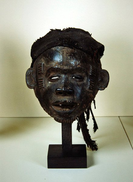Máscara Ogoja (madeira, algodão e penas) de Nigerian