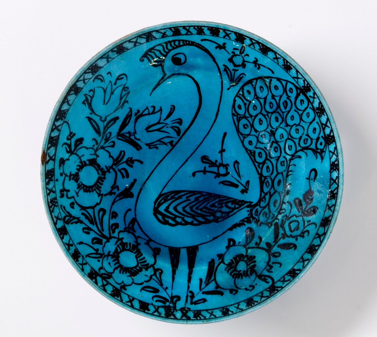 Um prato de cerâmica persa do século XIX, representando um pavão em um fundo turquesa de Persian School