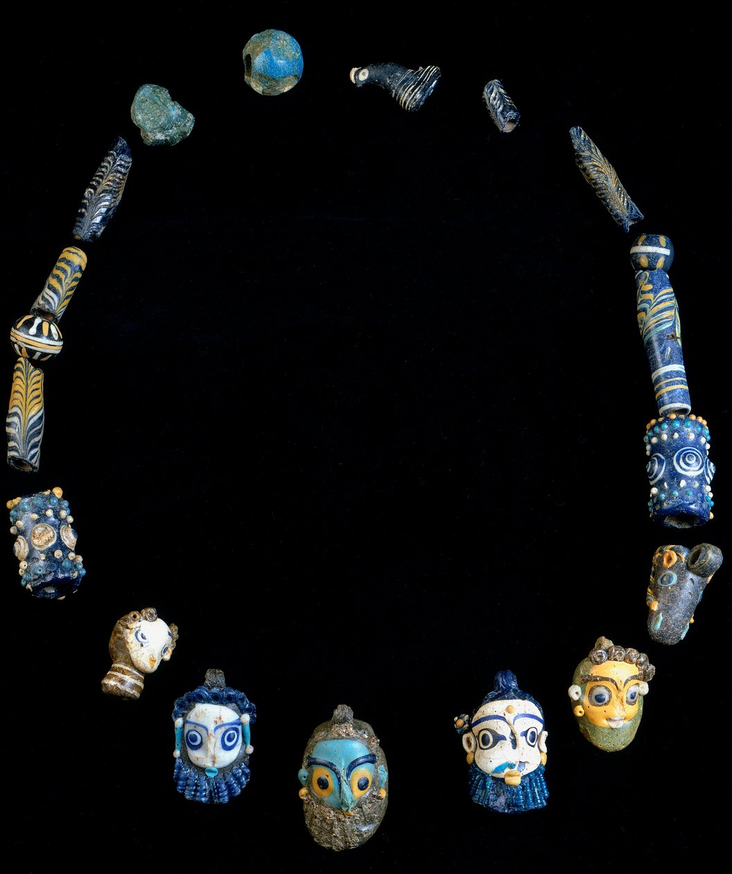 Colar em pasta de vidro com pingentes representando cabeças barbudas, originalmente de Olbia, agora conservado no Museu Nacional Arqueológico de Cagliari de Phoenician Phoenician