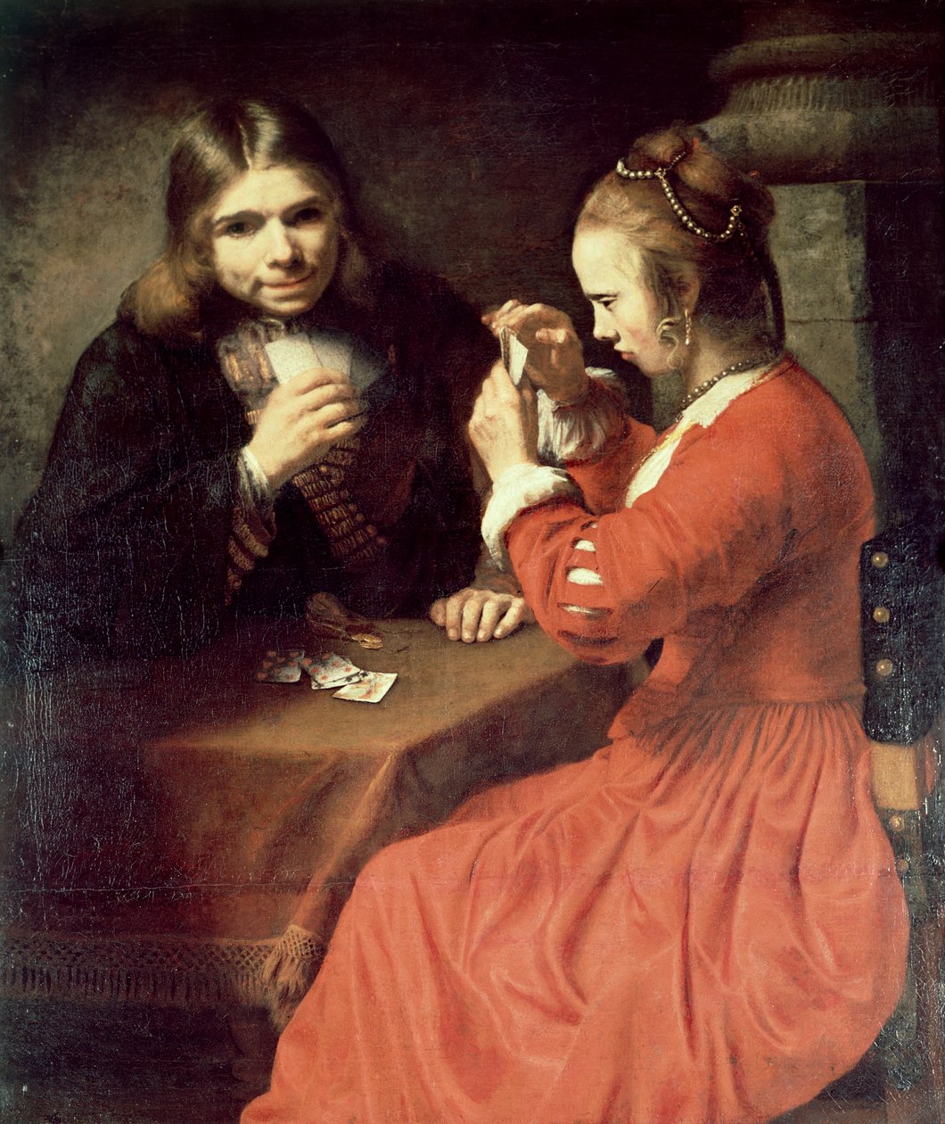 Um jovem e uma menina jogando cartas de Rembrandt van Rijn
