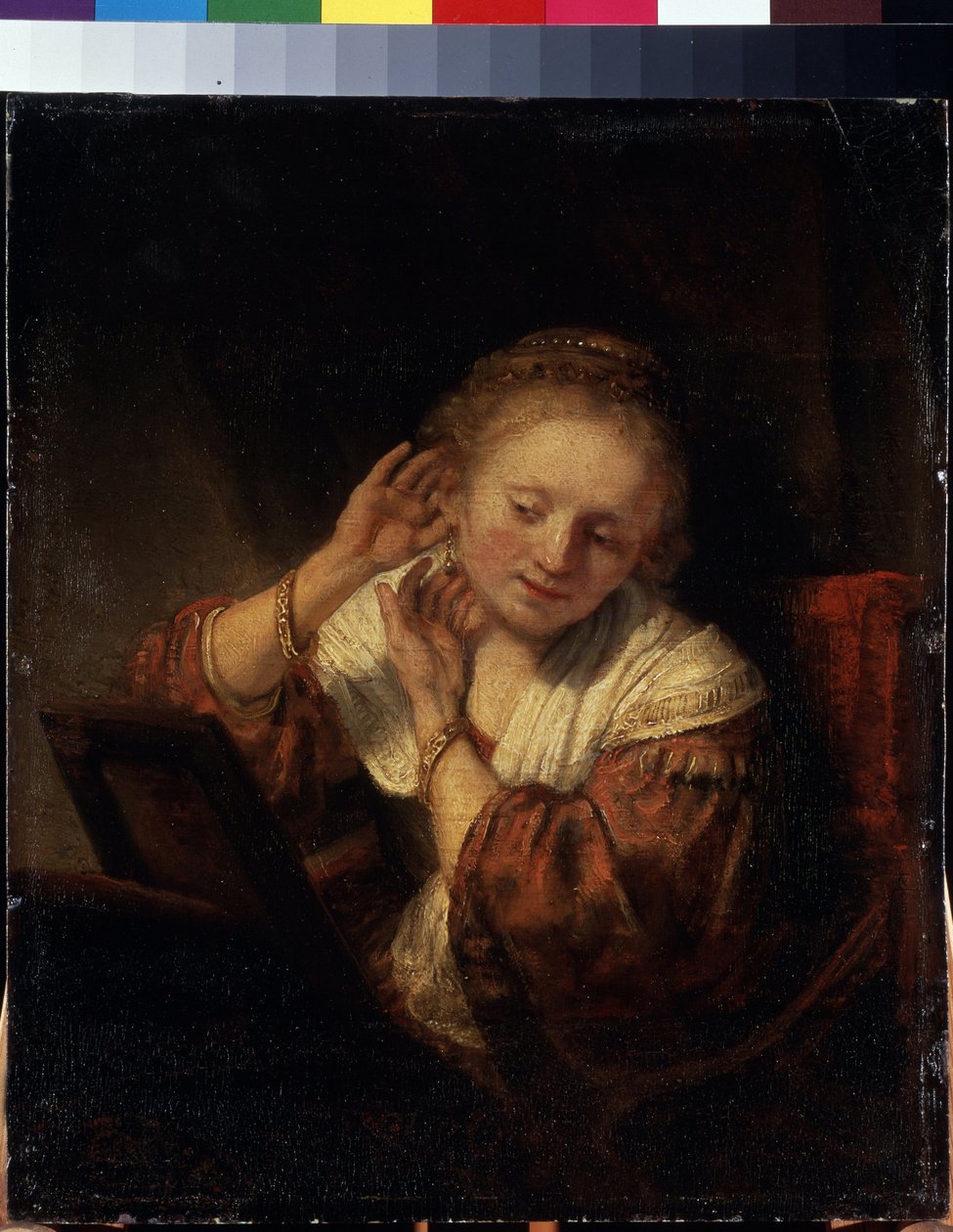 Jovem Mulher a experimentar Brincos. Jovem Mulher a experimentar Brincos. Pintura por Harmenszoon van Rijn (1606-1669) de Rembrandt Harmensz. van Rijn