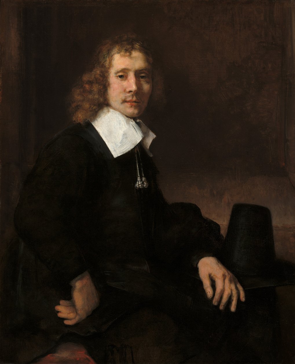 Um jovem sentado em uma mesa (possivelmente Govaert Flinck) de Rembrandt van Rijn
