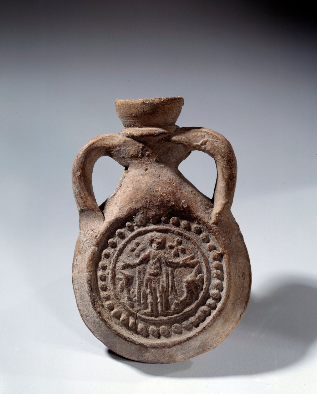 Arte Romana: Lâmpada de elogio em terracota com pé representando um santo. Século IV d.C. Paris, Museu do Louvre de Roman