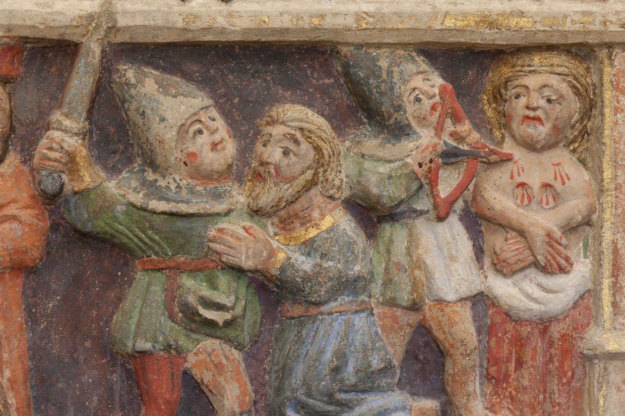 Peça de altar. Pedra policromada. Segunda metade do século XIV. Origem antiga igreja paroquial de Torre de Rialb. Pormenor. Registo médio. Painel esquerdo. Parte inferior: um oficial está olhando a cena da decapitação de Santo Iscle e a amputação dos seios de Unbekannt