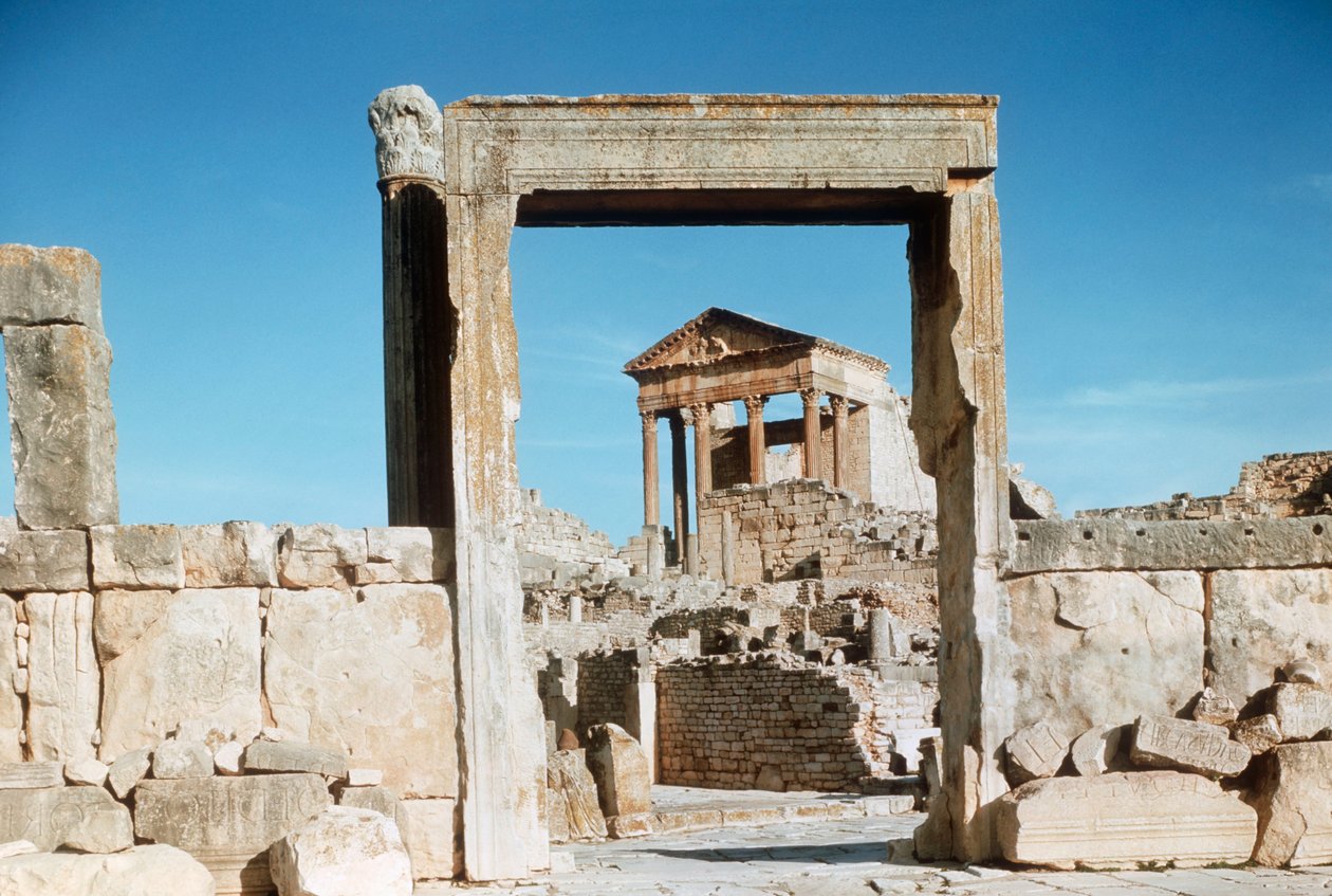 Tunísia, Dougga, ruínas romanas do Capitólio vistas através do portal Dar el Acheb de Benjamin Baud