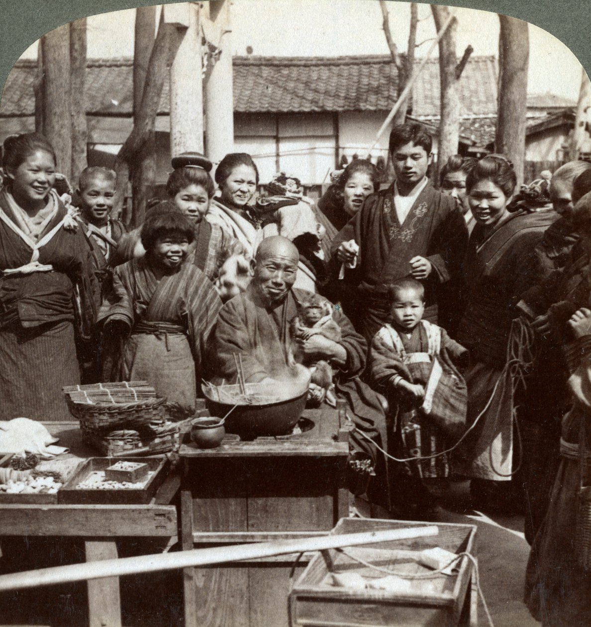 Um artista de rua com um macaco divertindo a multidão, Kobe, Japão, 1896. de Underwood and Underwood