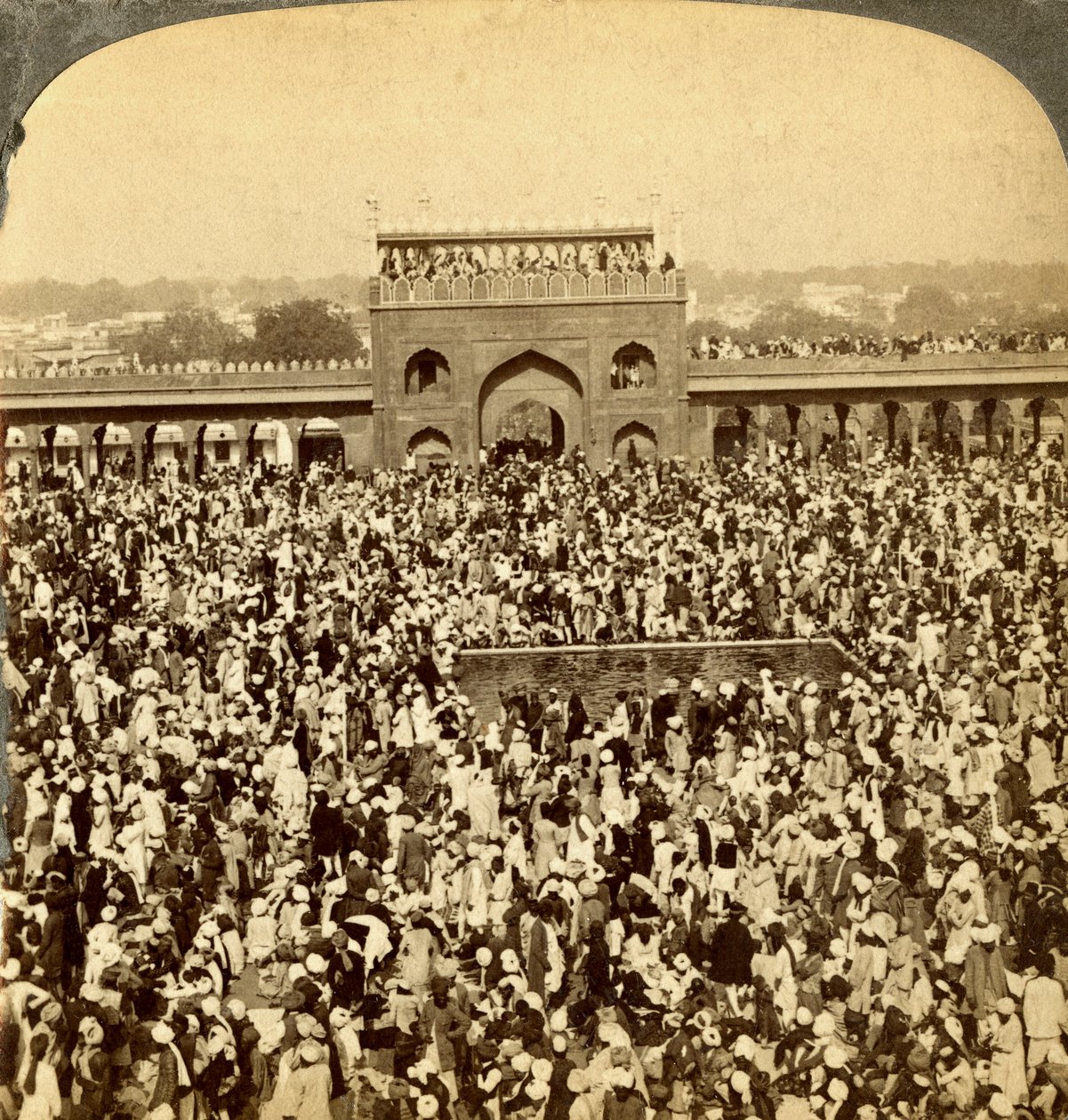Na corte da mesquita de Jumma durante o jejum anual, Delhi, Índia. de Underwood and Underwood