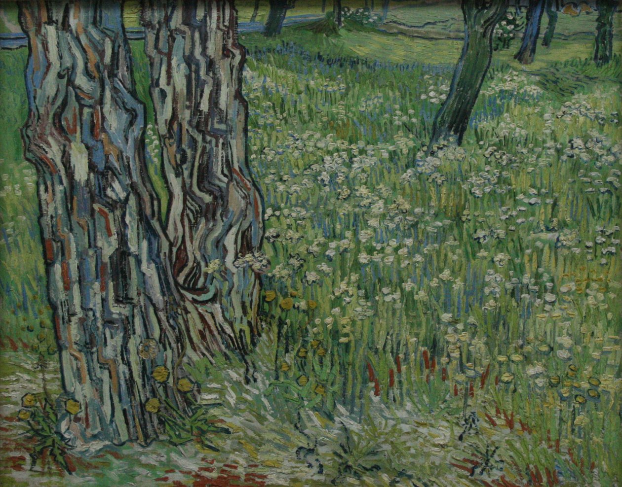 Troncos de árvores na grama de Vincent van Gogh