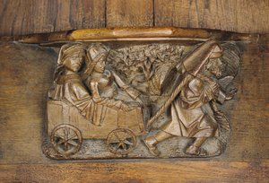 Escultura representando um casal em uma carroça puxada por um homem, de uma banca de coro (madeira) de French School