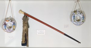 Guild e objetos de comércio, incluindo uma bengala e cabaças (madeira e cerâmica)