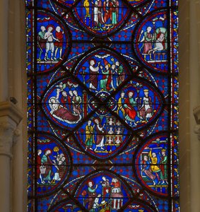 Vidro manchado da catedral de Chartres: detalhe da vida de São Tomás de Aquino de French School