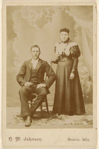 [Casal não identificado: homem de bigode sentado, mulher de pé]. de H. M. Johnson