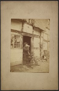[Homem sentado a beber de uma caneca na porta aberta]. de John Whistler