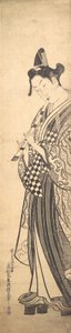Jovem caminhando para a esquerda em High Geta e tocando flauta enquanto caminha, ca. ..., cerca de 1745. de Okumura Masanobu