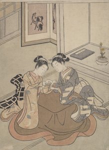 Duas moças sentadas ao lado de um berço de gato brincando de Kotatsu, ca. 1765., c. 1765. de Suzuki Harunobu