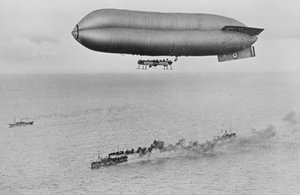 RNAS Coastal Class Airship C23A Voando acima de um comboio de navio de guerra, c.1917
