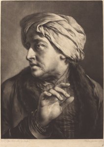 Um homem com um turbante e camisa listrada