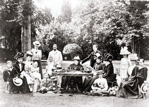 Membros da Família Real Britânica, incluindo o Rei George V, o Rei Edward VIII em torno da Rainha Victoria numa festa no jardim. Fotografia entre 1895 e 1901. de Unknown photographer