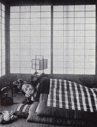Menina a dormir entre colchas com almofadas de madeira (foto a p/b) de American Photographer (after)