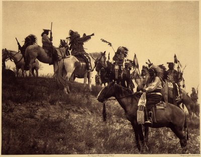 Planear uma rusga. Os índios, com os seus impressionantes trajes típicos, reúnem-se em grupos extremamente pitorescos. Trata-se de uma tropa de Sioux Ogalala (Oglala), numa colina com vista para o Vale de Wounded Knee, na Reserva de Pine Ridge, Dakota do S de Edward Sheriff Curtis