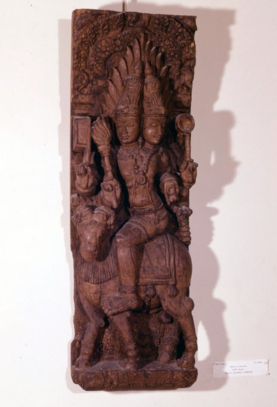 Agni, deus do fogo, representado com duas cabeças (bicéfalos) sobre um carneiro, segundo a mitologia hindu. Escultura de madeira do século XVII. Paris, Musée Guimet. de Indian School
