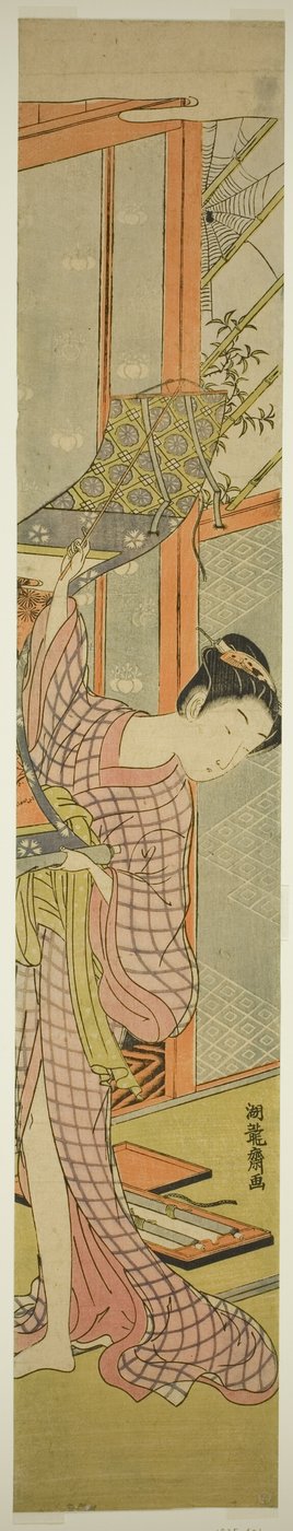 Jovem mulher pendurando uma pintura de Isoda Koryusai