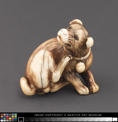 Netsuke modelado como um cachorro coçando o pescoço de Japanese School