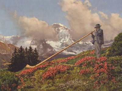 Suíça: Um Alphorn Blower, o Jungfrau no fundo (foto a cores) de Jean Gaberell
