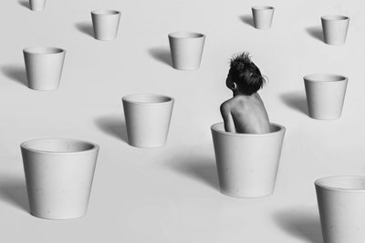 Criança entre vasos brancos de Karim Aboukelela