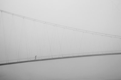 Passeio solitário numa ponte enevoada de Krunoslav Nevistic