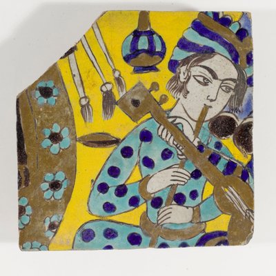 Um azulejo de cerâmica Safavid Persia cuerda seca do final do século XVII, representando um homem tocando flauta em um turbante de Persian School
