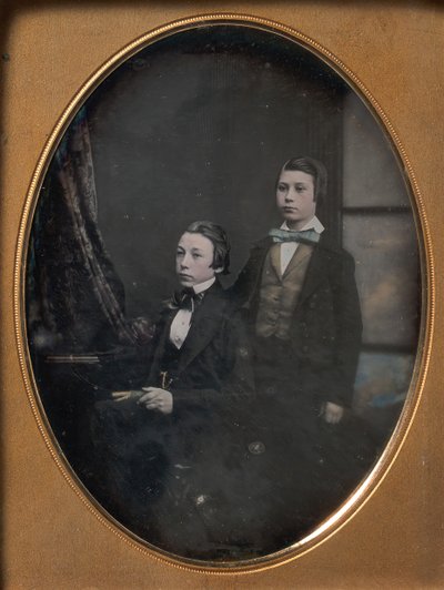 Dois rapazes de gravata borboleta, um sentado segurando um livro, outro em pé, década de 1850. de Robert Boning