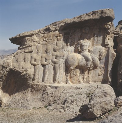 Relevo de rocha representando Shapur I (241-72 dC) e sua família usando emblemas heráldicos em seus chapéus, com uma inscrição em três línguas no cavalo em grego, parta e persa médio. de Sasanian