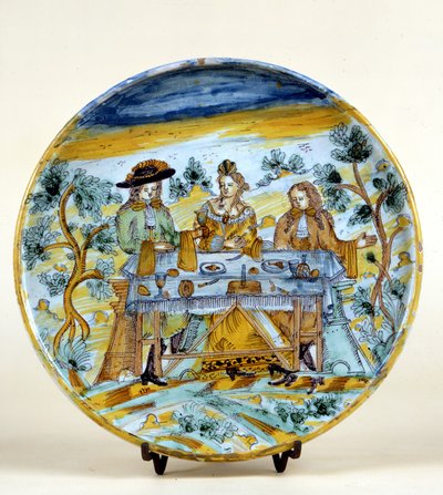 Representação de um banquete ao ar livre numa placa cerâmica de Talavera de la rejna (Espanha). Início do século XVI. Milão, Museo del Castello. de Spanish School