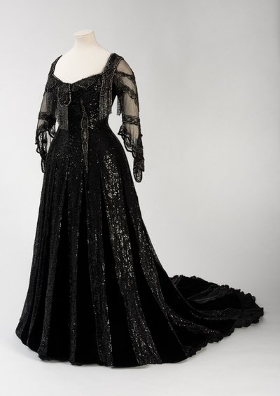 Vestido de noite preto de comprimento total usado pela Rainha Alexandra, com decoração de missangas e lantejoulas e incorporando a assinatura da Rainha Alexandra em seda preta e fita com letras douradas, feita pela Barolet of Knightsbridge, Londres 1908-19 de Unbekannt