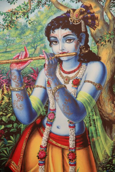 Pintando representando o deus hindu Krishna tocando uma flauta ao ar livre. Índia de Unbekannt