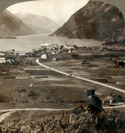 Telhados da vila e campos ensolarados de Odde, N. até o estreito Sorfjord com paredes de montanhas, Noruega, 1905. de Unbekannt